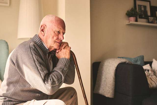 Elderly man sitting alone
