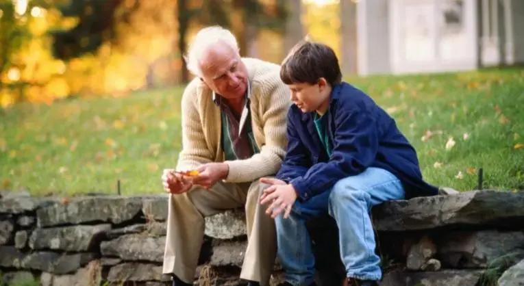 Boy and grandfather talking